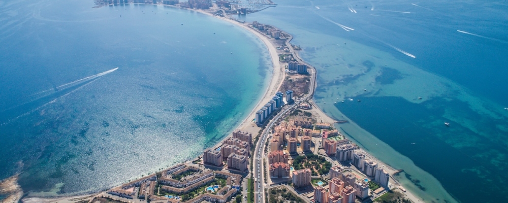 Living on the Mar Menor - Aerial view of the Mar Menor saltwater lagoon on Spain's Costa Cálida, with Los Alcázares beach and the La Manga strip in the distance